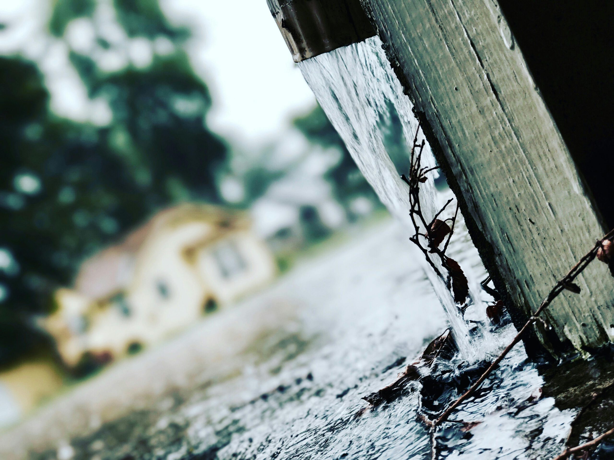 Close-up of rainwater flowing from a gutter during a storm